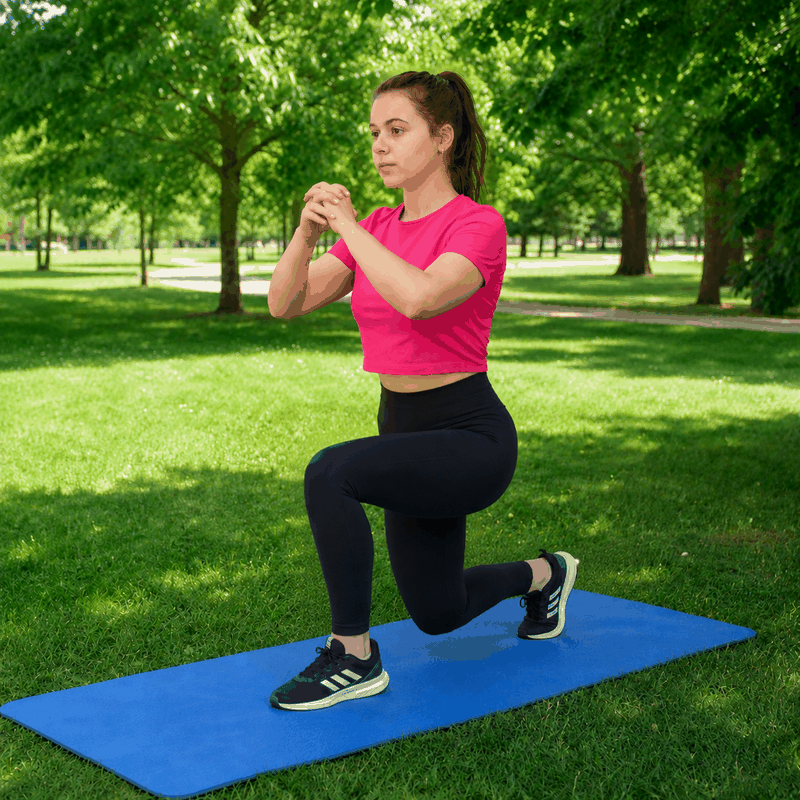 Woman performing a reverse lunge outdoors