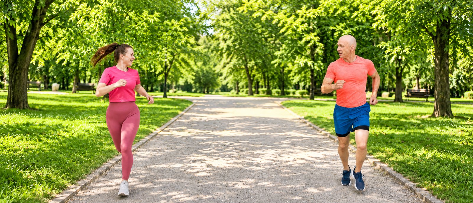 Father and daughter running outdoors in a park